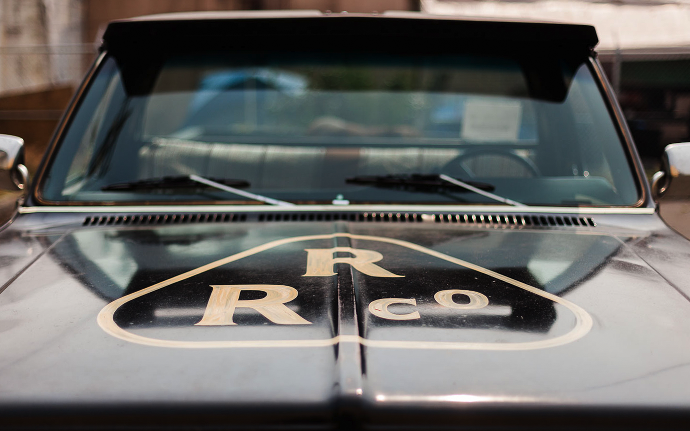 Rainier Roofing R/R Co. diamond logo on the hood of a vintage black pickup truck