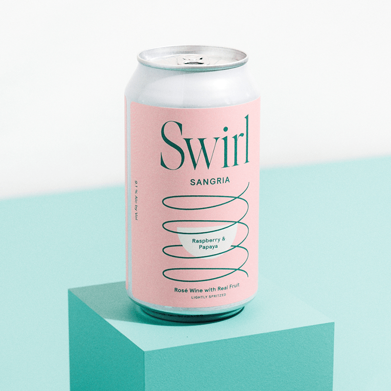 Single Swirl Sangria Raspberry and Papaya pink can on a teal green pedestal