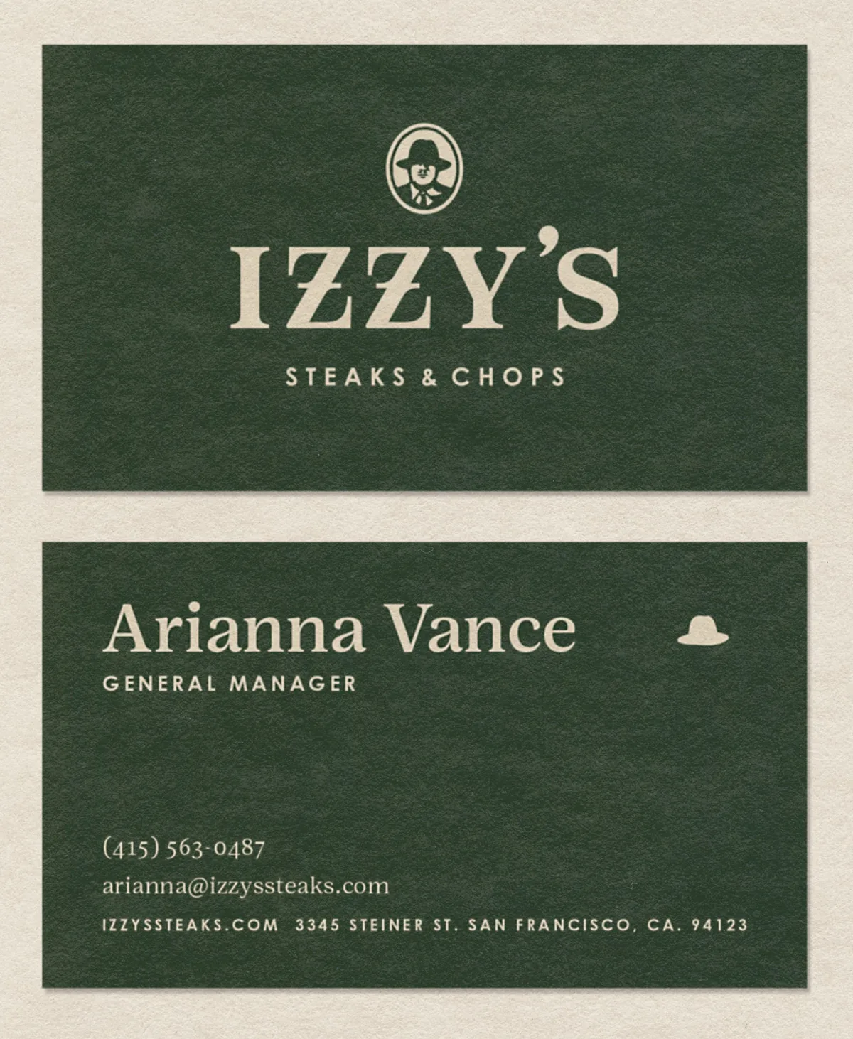 Izzy's Steaks & Chops business card mockup — front with logo, back with general manager contact details