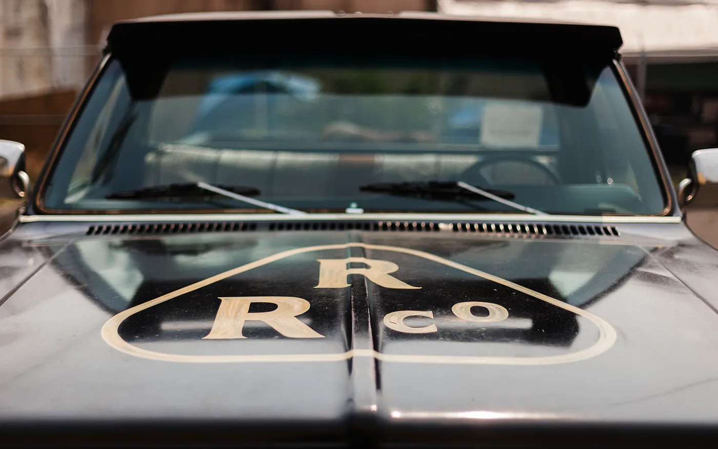 Rainier Roofing R/R Co. diamond logo on the hood of a vintage black pickup truck