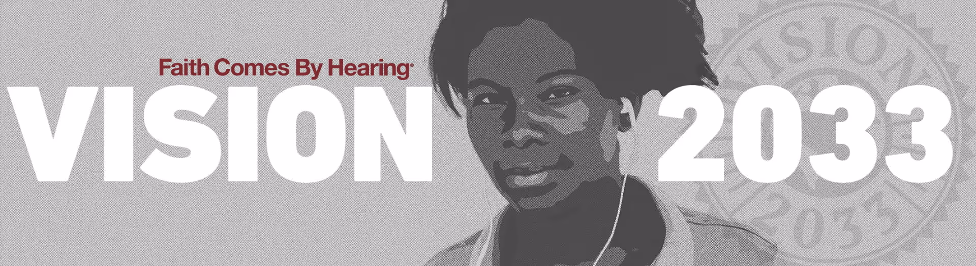 Man on a bicycle in a village with a 50th anniversary logo