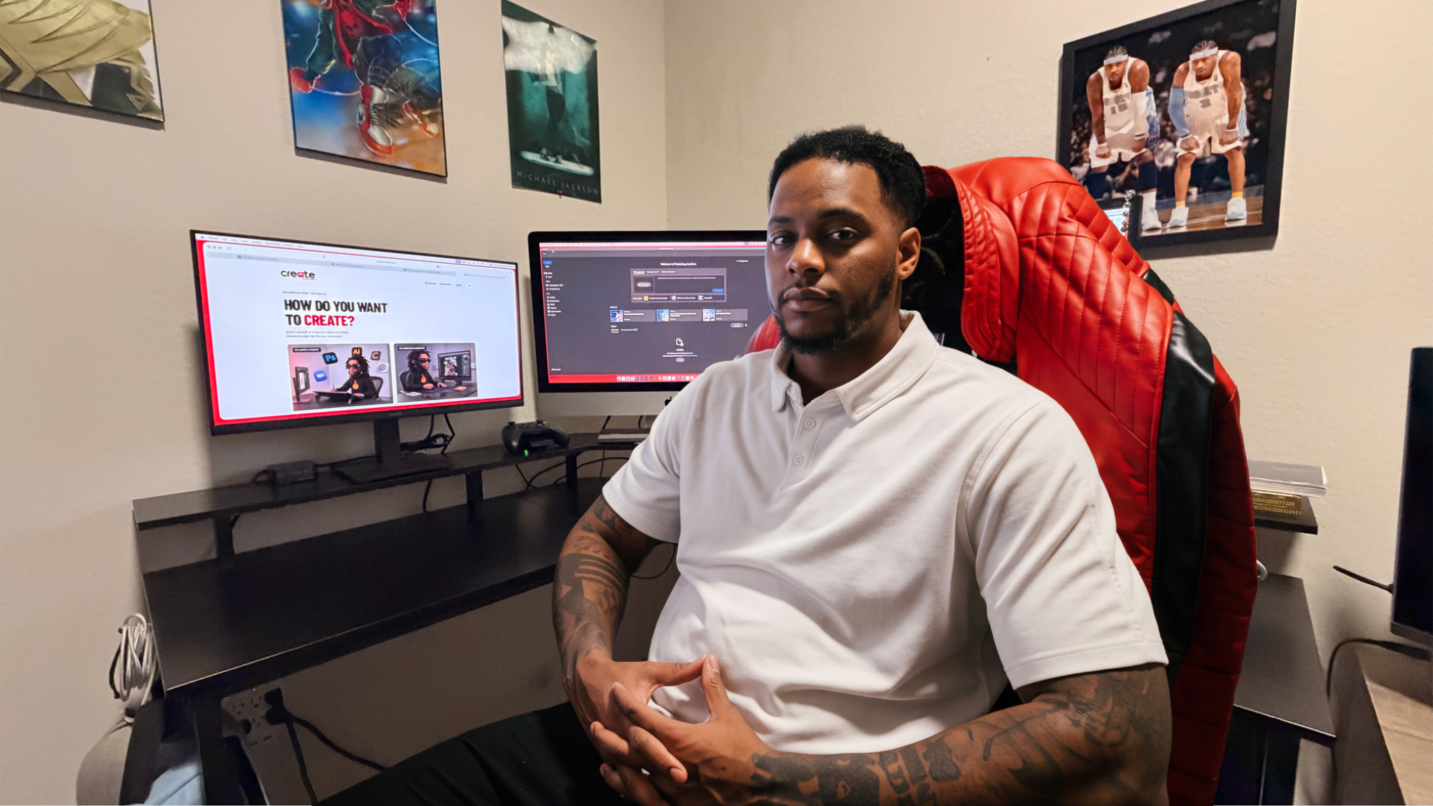 Jon Bracken seated at his graphic design workstation in a white polo