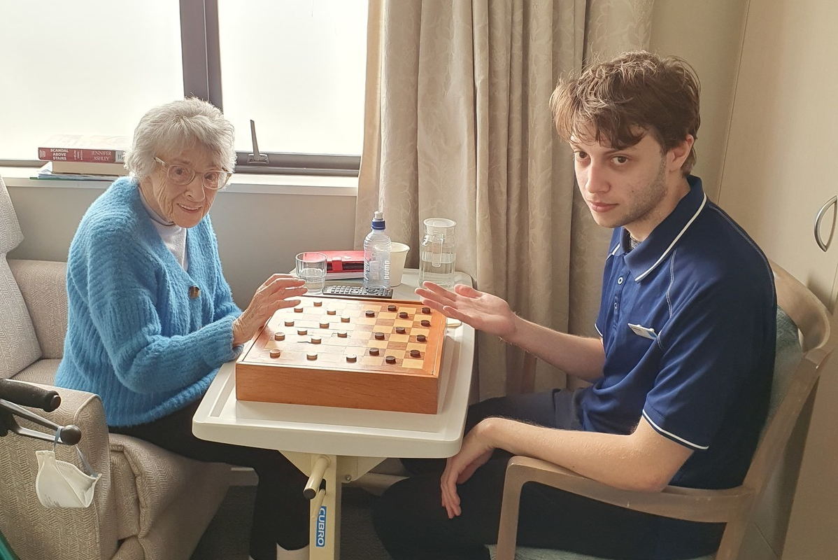 Joshua with a resident of the Bupa Parkstone Retirement Village.