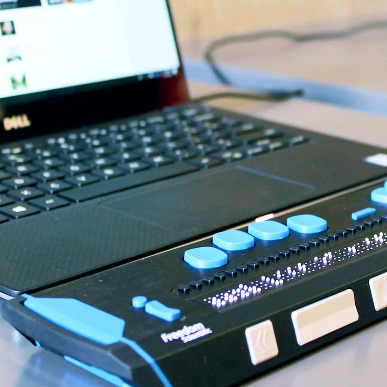 A braille terminal attached to a laptop.