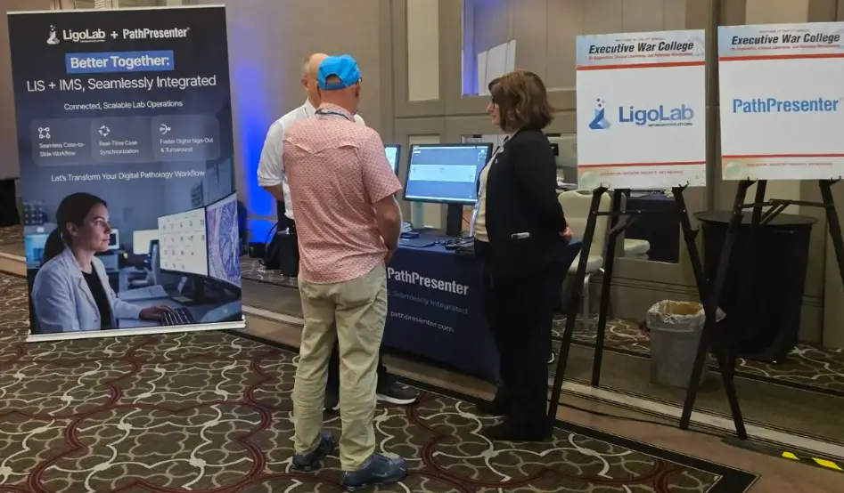 LigoLab and PathPresenter booth at Executive War College, showing attendees discussing LIS and IMS integration for digital pathology.