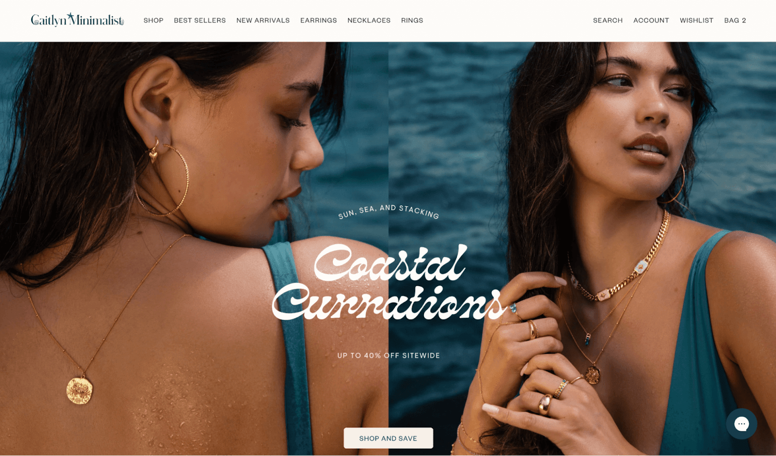 Caitlyn Minimalist homepage showing women wearing layered gold jewelry, including hoop earrings, necklaces, and rings, posing by the ocean with the text "Coastal Curations – Up to 40% Off Sitewide."