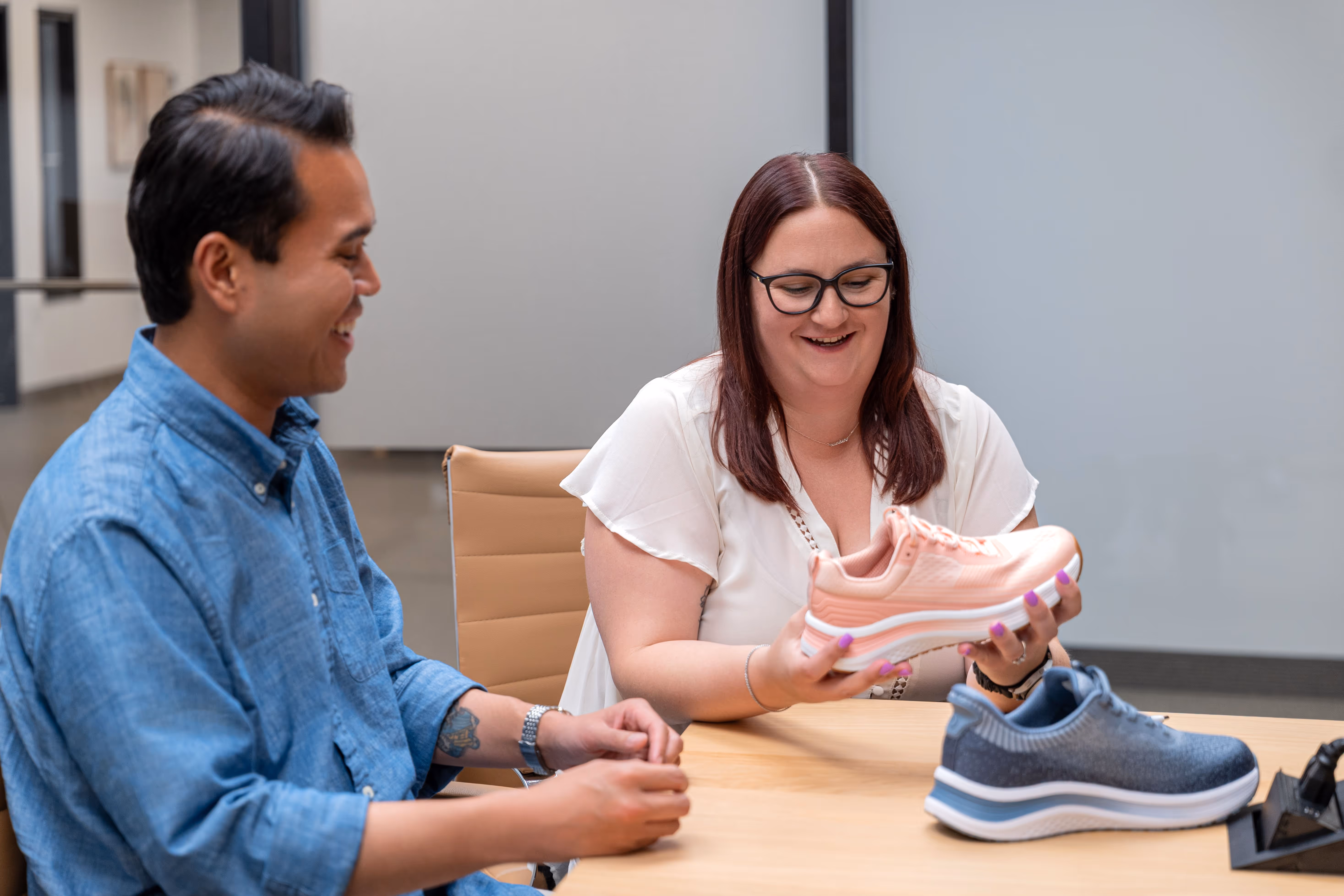 Orthofeet employees looking at an orthopaedic shoe.