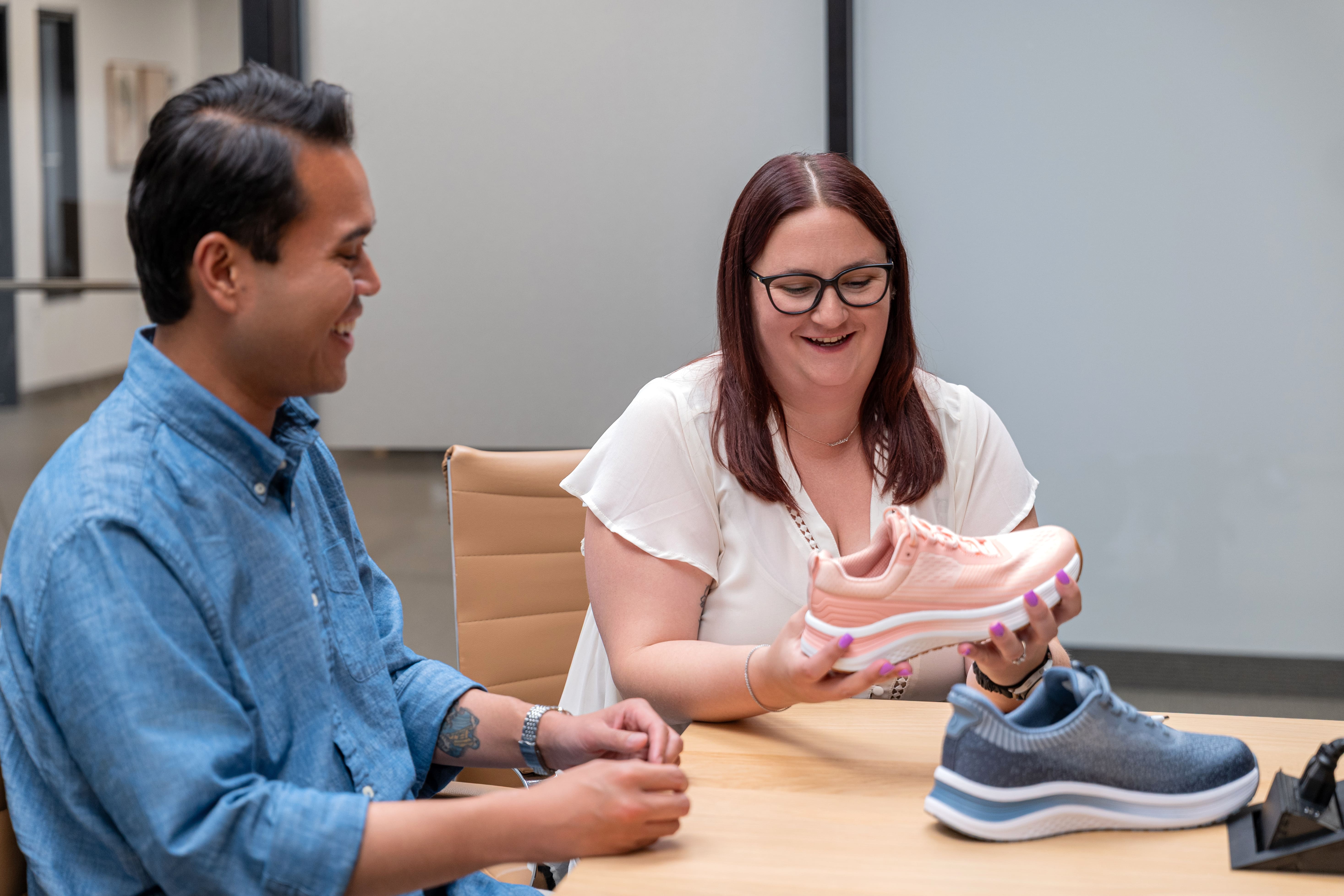 Orthofeet employees looking at an orthopaedic shoe.