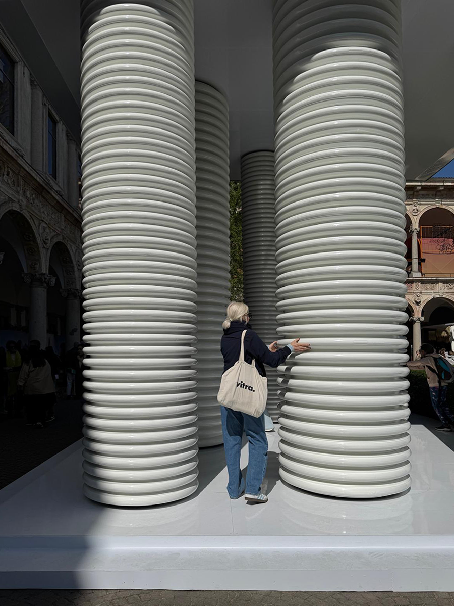studiokuehn creative director katharina kühn is positioning pillars at an installation during the Salone di Mobile 2025