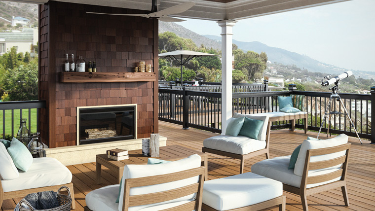 Deckorators deck with ample seating and a fireplace.