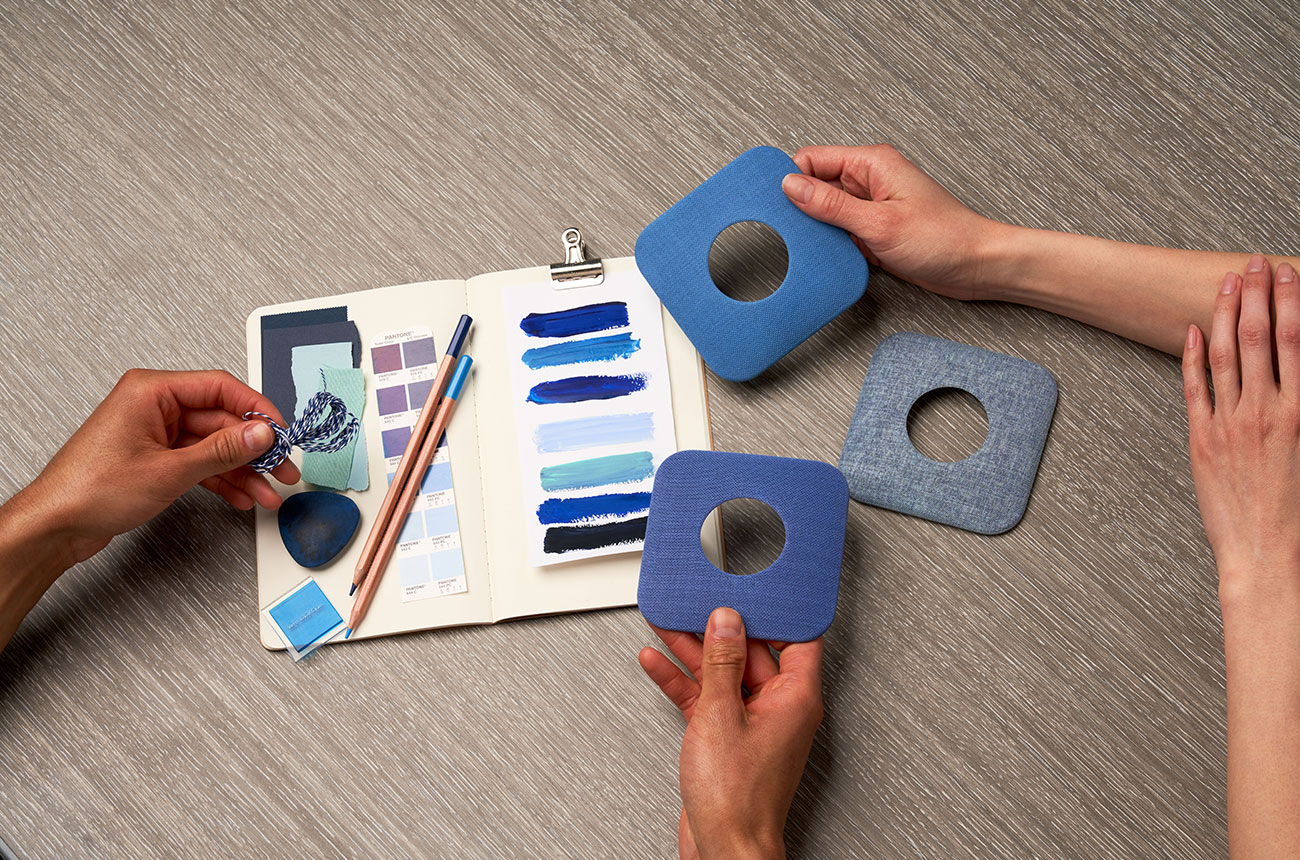 hands comparing color swatches