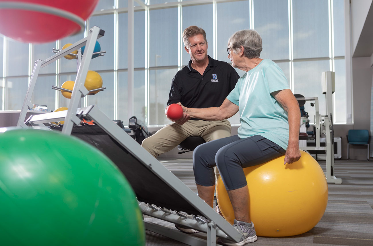 older woman doing physical therapy