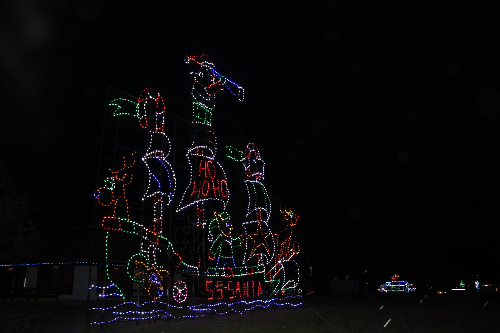 Holiday light display against  a black night sky. 