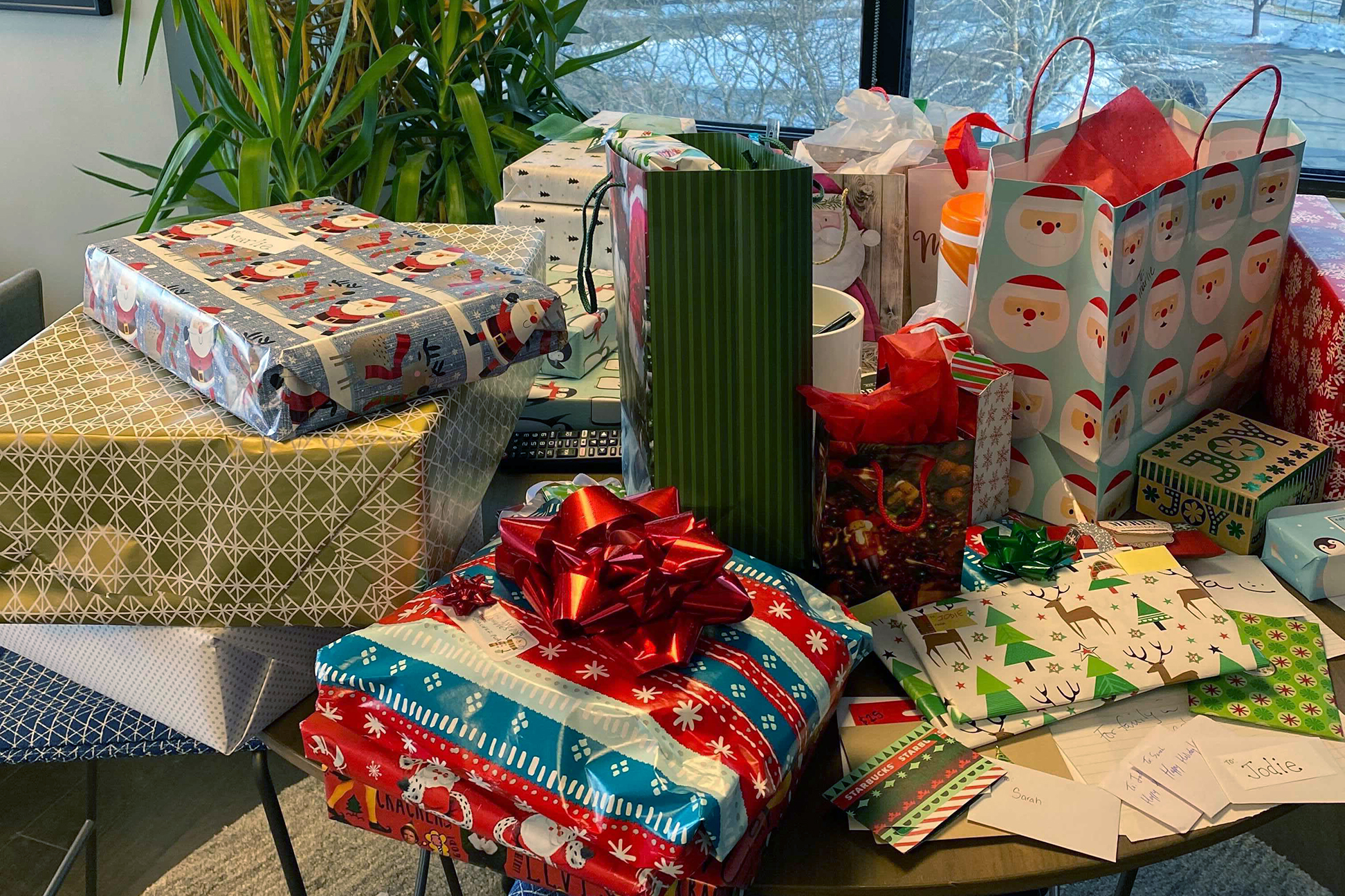  A pile of wrapped presents sitting on a table. 