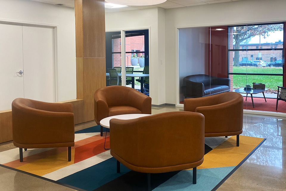 Seating area within the Anthologic office with four chairs surrounding a coffee table. 
