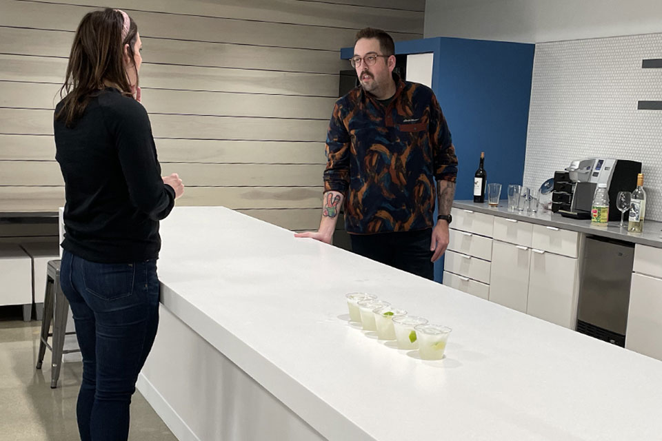 Two Anthologic employees conversing in the kitchen area. 