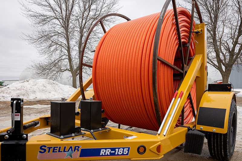 A RR-185 self-loading single-reel cable trailer with orange cable. 