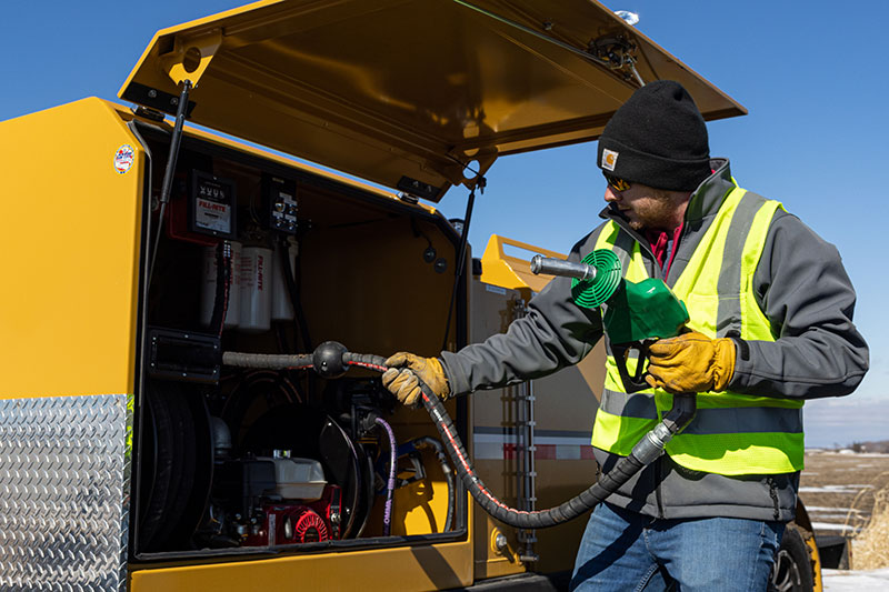Operator using the 990DLX Deluxe Fuel Trailer. 