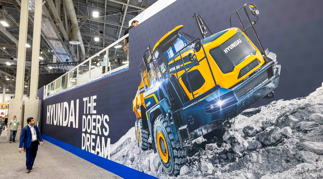 Trade show wall graphic displaying Hyundai machinery and the text “Hyundai The Doer’s Dream”.