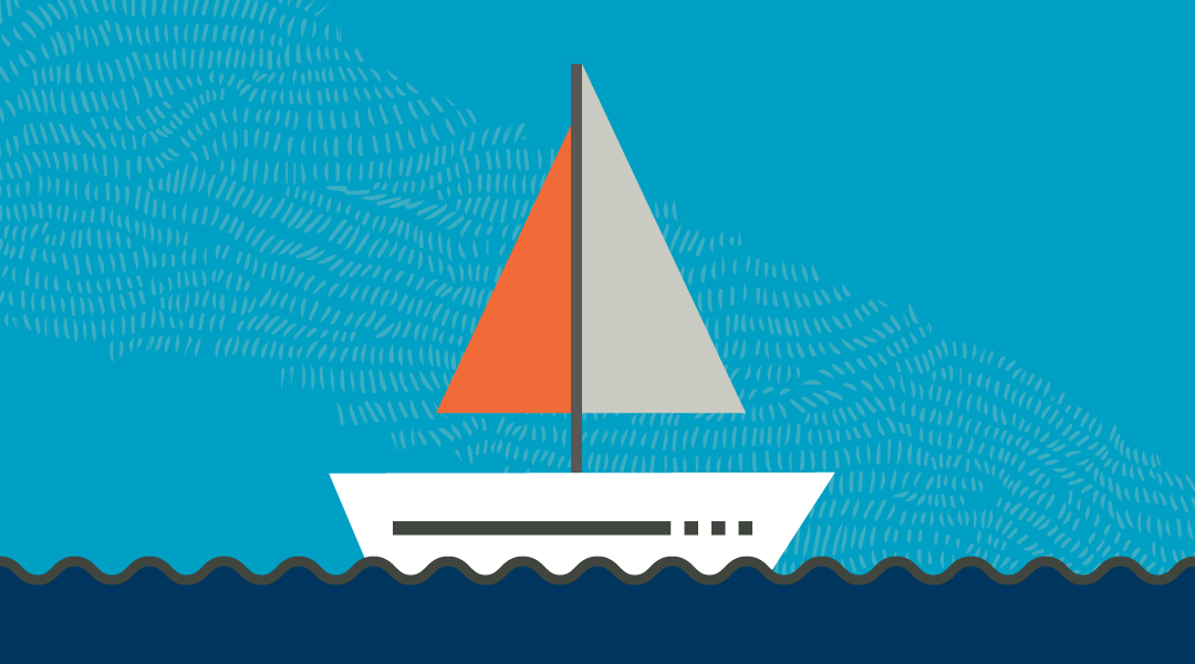 White, grey and orange sailboat on the water. 