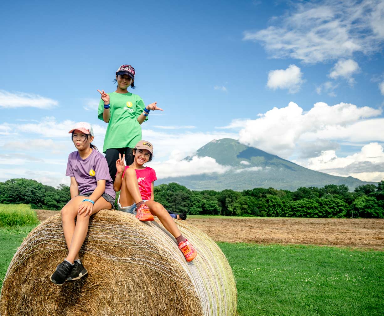 EdVenture team member with camper in garden