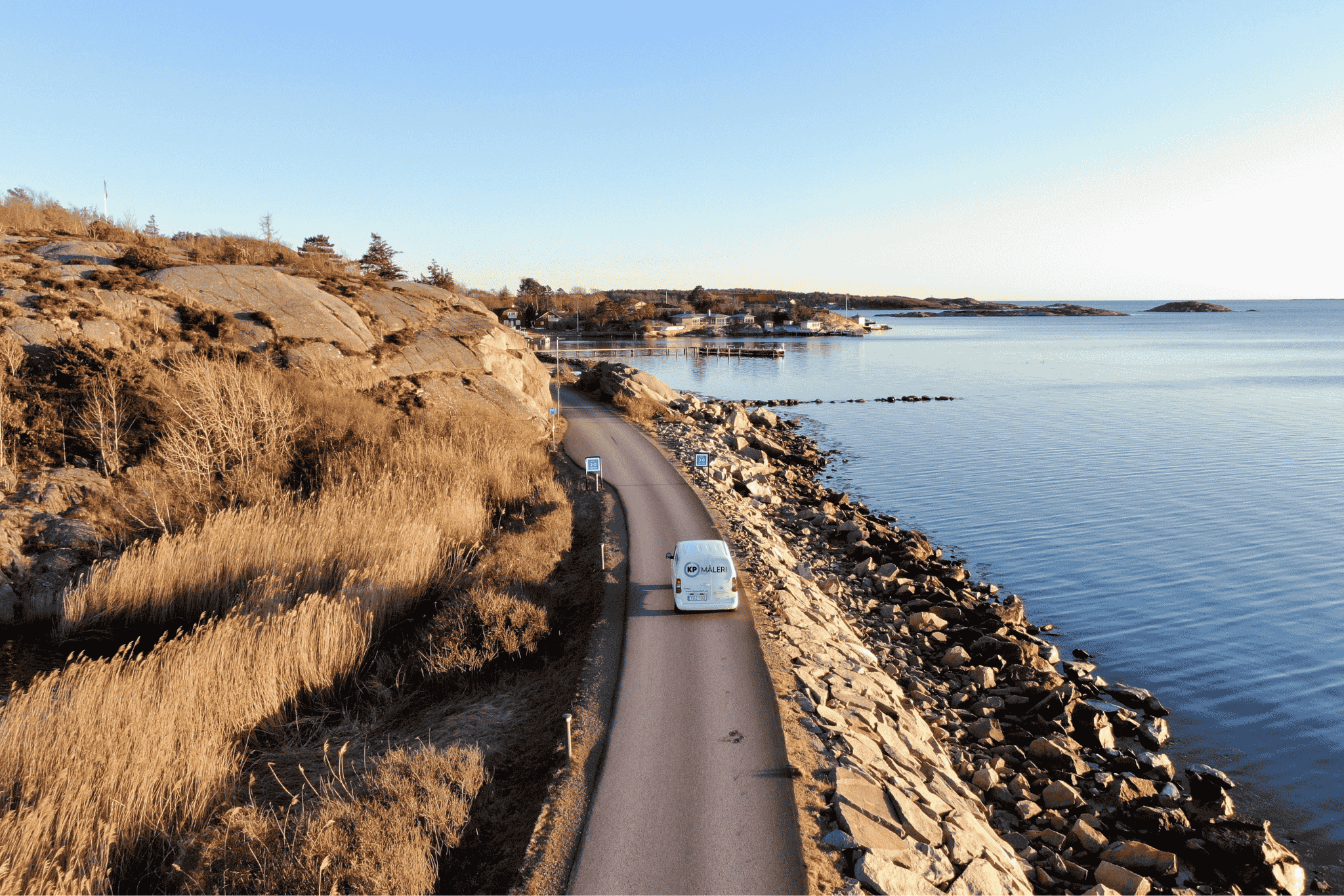 Målar vägg och golvlist med vit färg