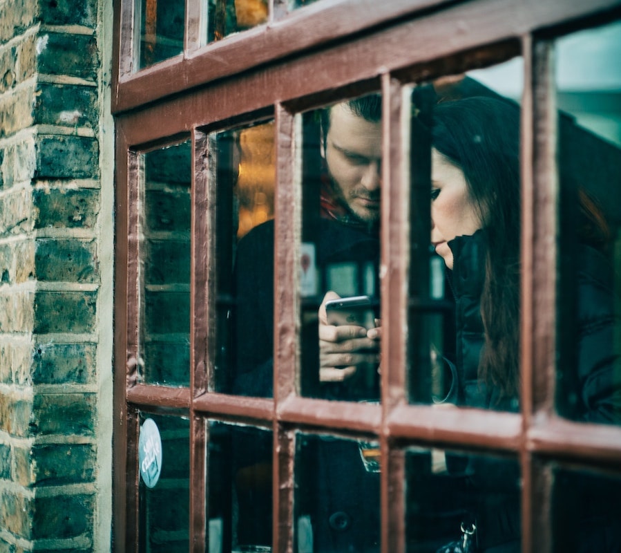 Couple on Phone through Window