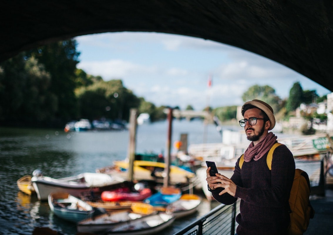 Man on phone near canal