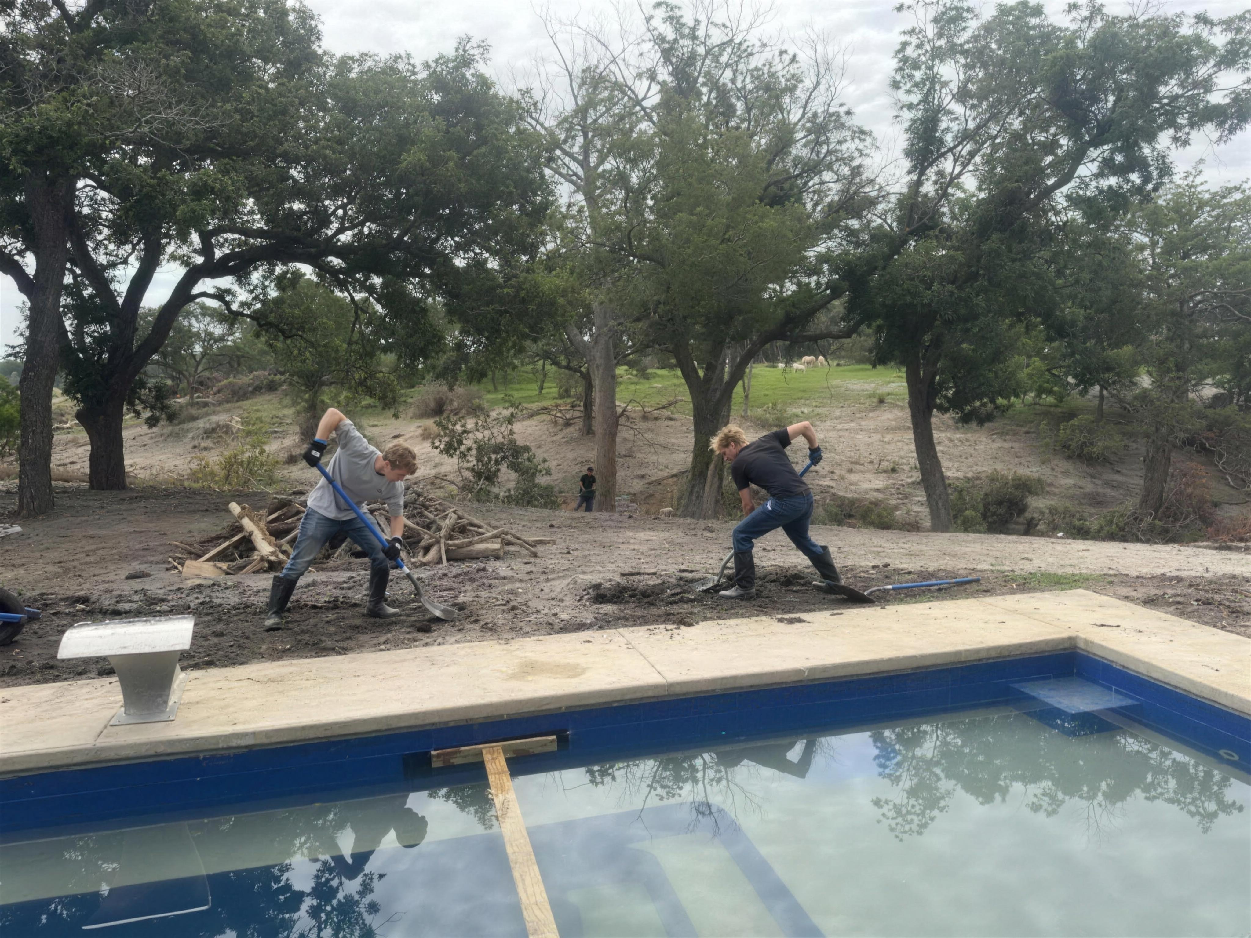 Flood mud surrounding a swimming pool at a Texas Hill Country home