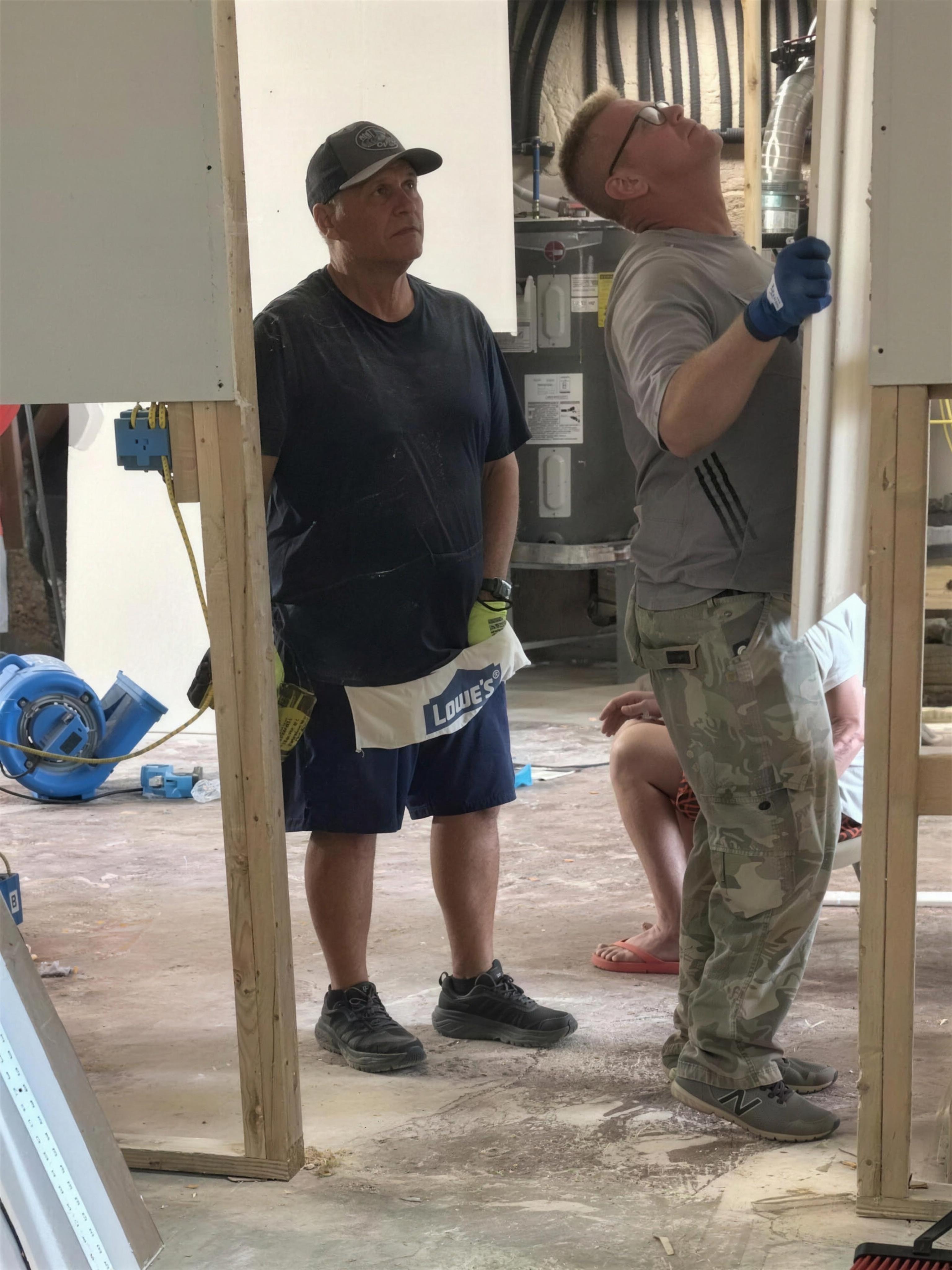 Volunteers working inside the gutted home