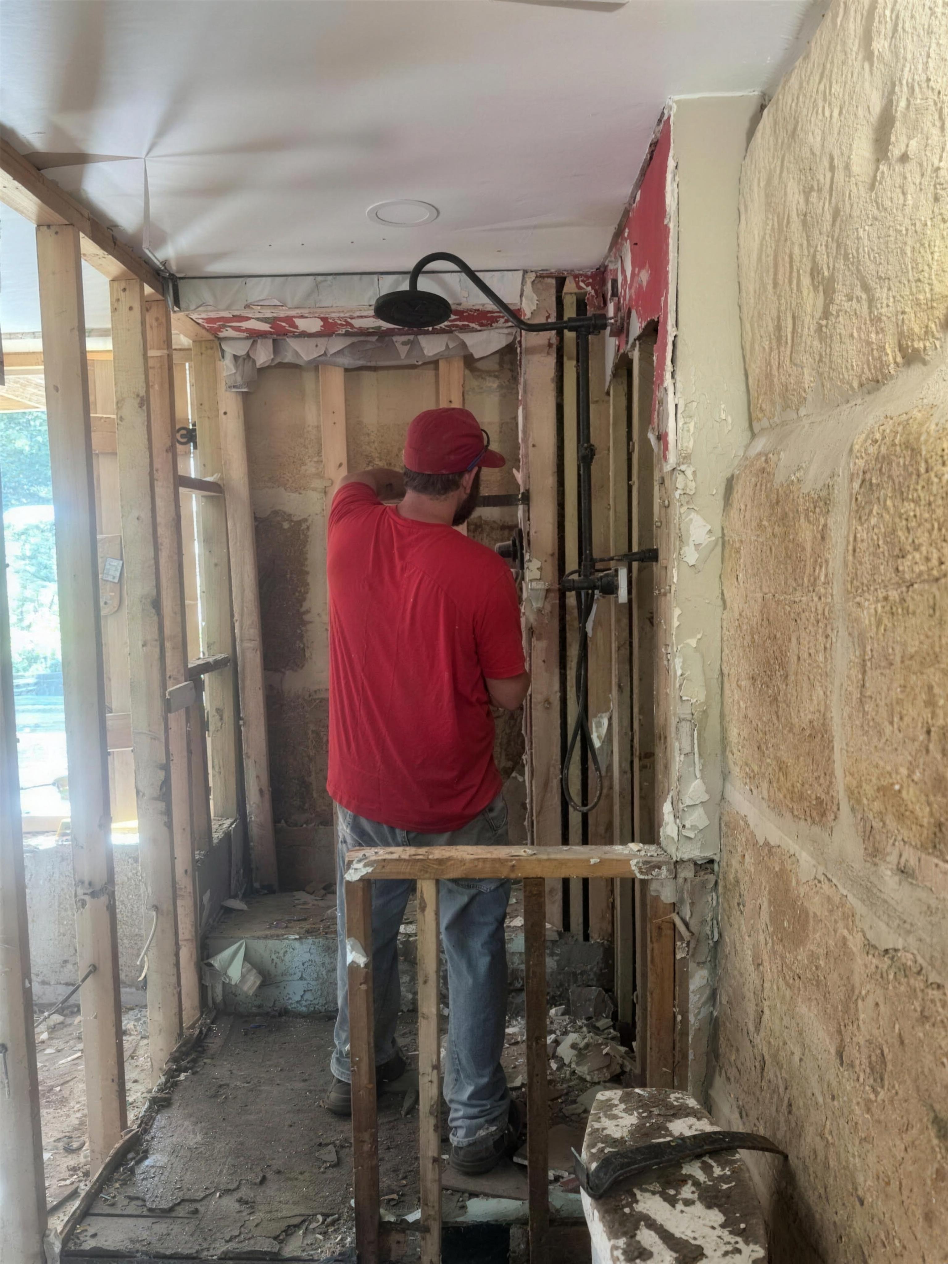 Volunteer working on exposed framing during the rebuild