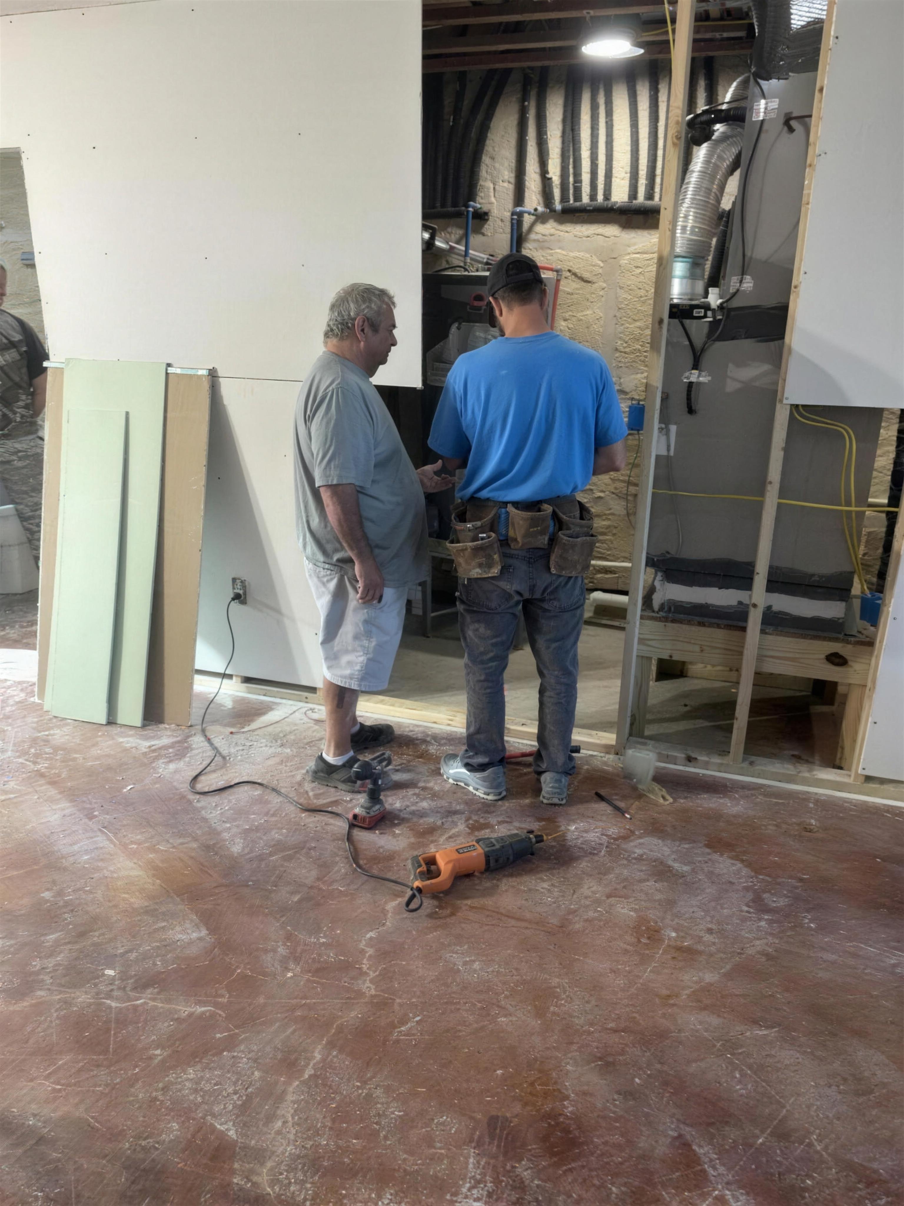 Volunteers moving drywall inside the home