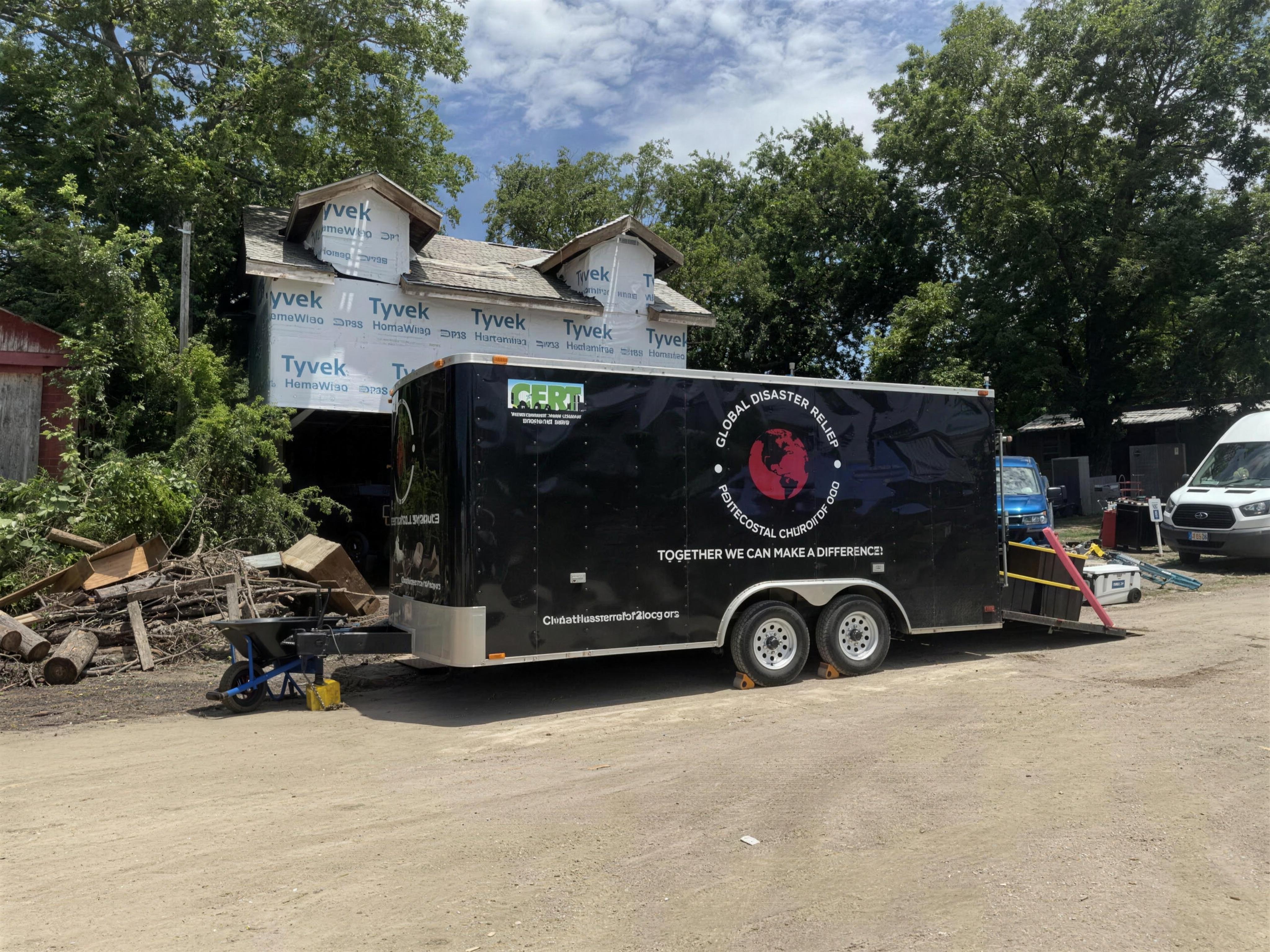 PCG Disaster Relief trailer parked outside a flood-damaged home in the Texas Hill Country