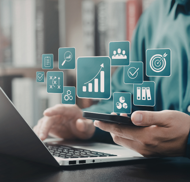 Person seated in front of laptop with abstract data icons centered on the image