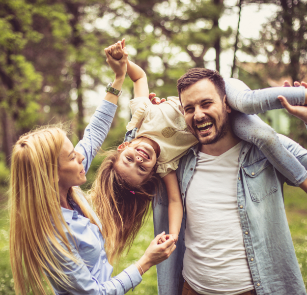 Two parents and a child playfully interacting.