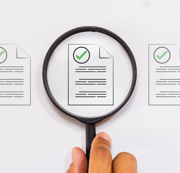 A document with a green checkmark on it, being inspected through magnifying glass.