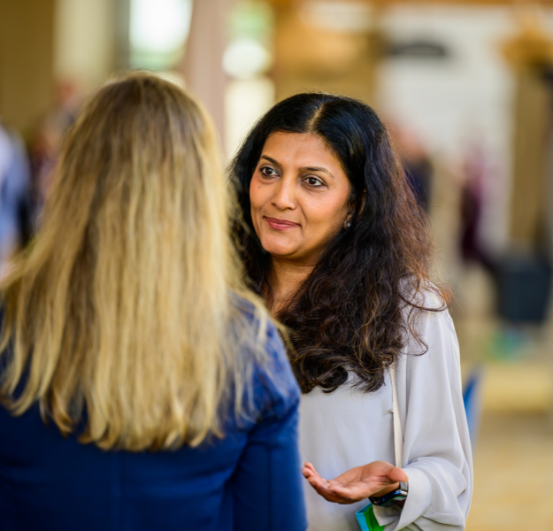 Image of two women talking.