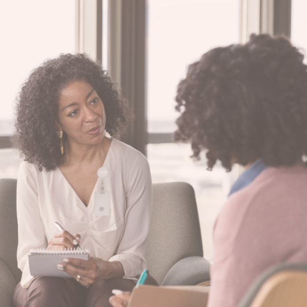 Image of two women talking.