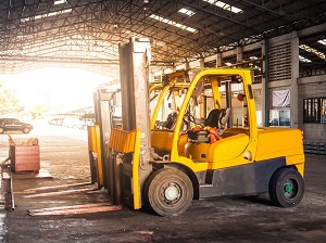 Forklifts parked and waiting to be used in a covered loading area.