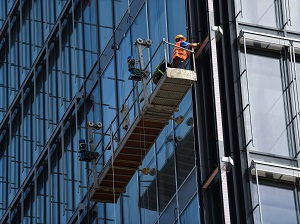 View of a suspended scaffold high on a building.