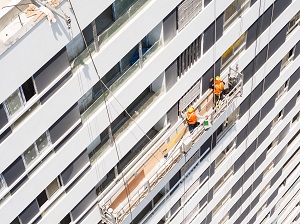 Aerial view of a suspended scaffold with two workers on it.