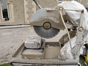 Stationary masonry saw sitting at a construction site, not currently in use.