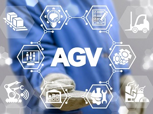 Worker standing behind a graphic showing AGV symbols.