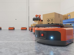 Automated Guided Vehicles transporting packages in a warehouse.