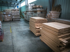 Warehouse with neatly stacked flooring planks.