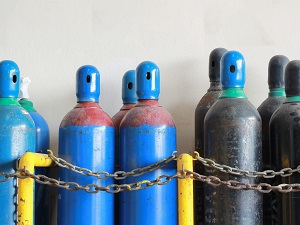 Compressed gas cylinders stored upright.