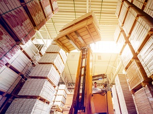 A telescoping forklift being used in a warehouse.