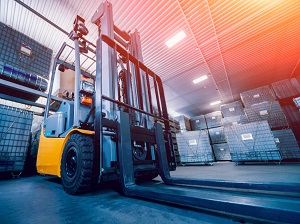 A forklift parked in an area near a loading dock.