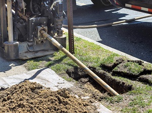 Boring machine using horizontal directional drilling technology at an excavation site.