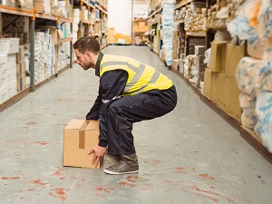 Warehouse worker lifting a box.